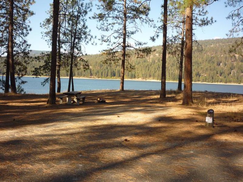Kettle Falls Campground with trees and water in the background.