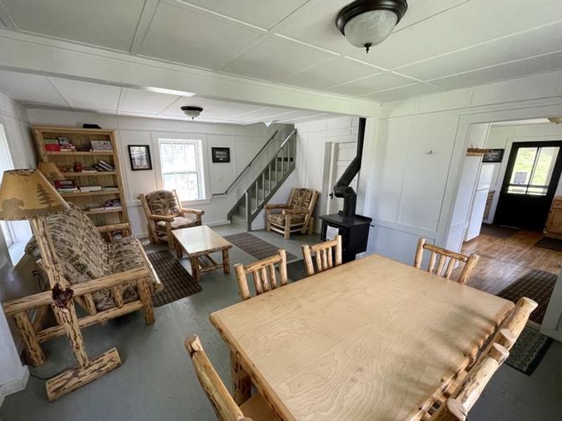 Swan Guard Living/Dining 
Dining table for 6, couch, 2 chairs, bookcase stocked with games/books, propane fireplace