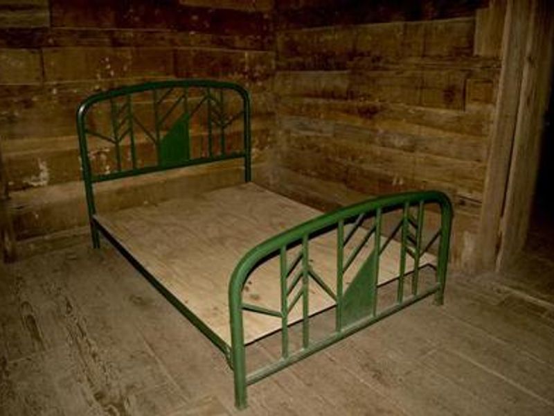 Full size metal bed frame inside cabin