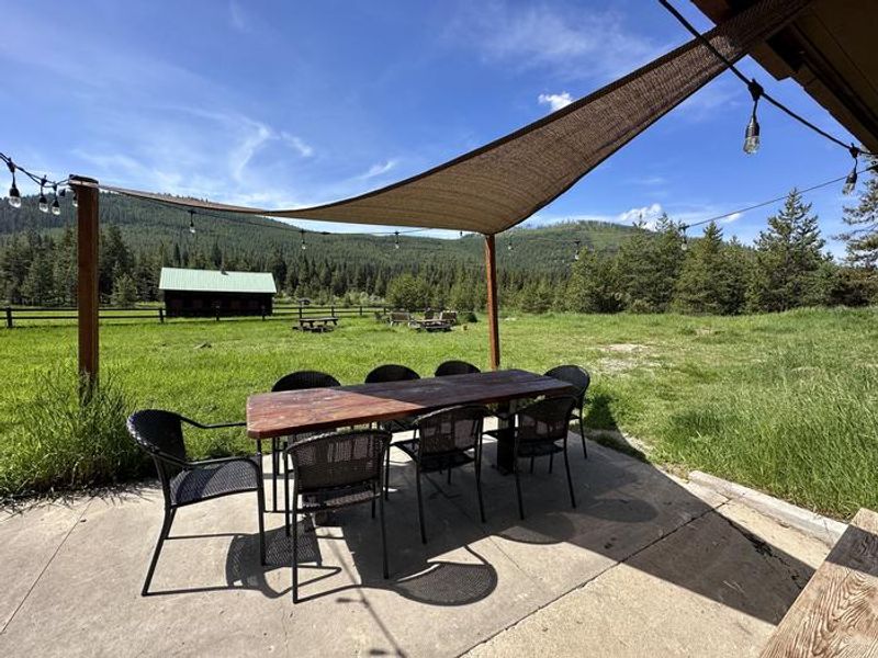 Star Meadow Guard Station back patio with tables, charcoal grill and electricity. Large yard and horseshoe pits too.