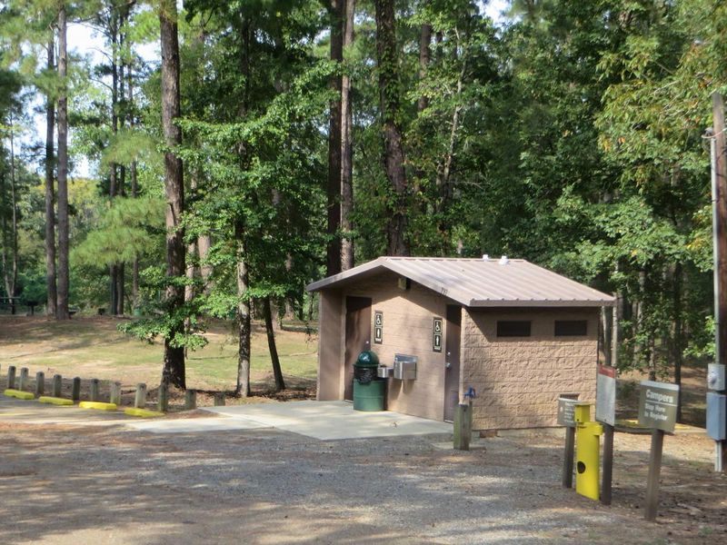 Flushing toilets, running water sinks, and drinking fountain amenities located within the comfort station. 