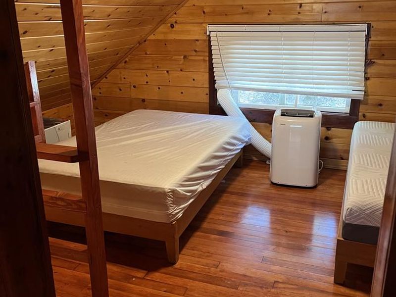 Two full mattresses and portable AC unit. 