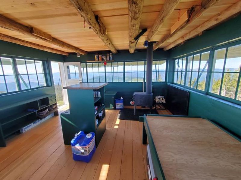 A wood stove, a bed, and a beautiful view.