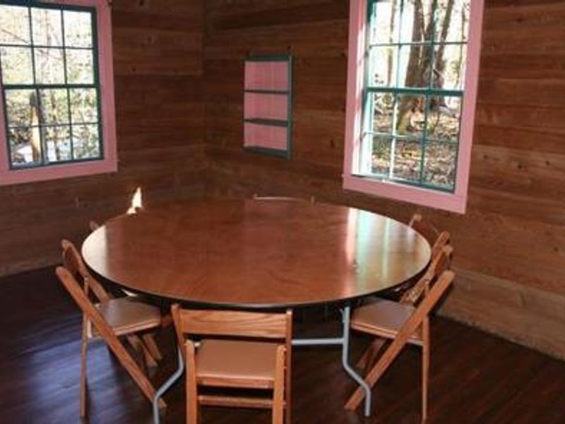 dining table with chairs in one of the side rooms of Spence Cabin