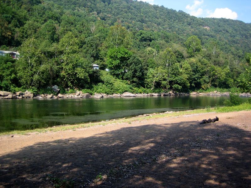 The swift water New River at Army Camp offers fishing and relaxation opportunities near your campsite.