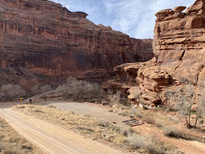 Overview of group campsite with cliffs in background.