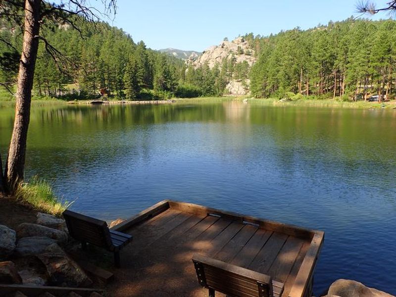 Fishing pier overlooking lake with benches