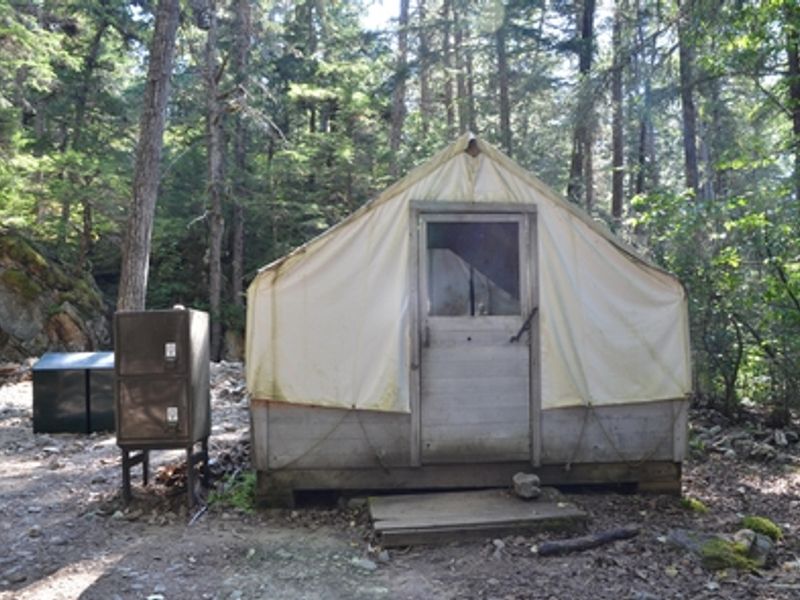 The wall tent can be used for cooking or shelter.  Two sets of metal bear boxes are located nearby for all items with a scent.