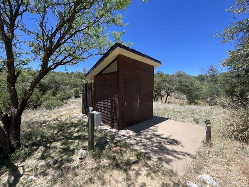 Vault toilet located within 100 feef of the cabin.