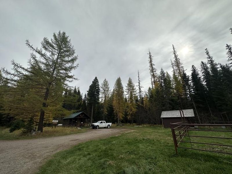 Owl Creek cabin in fall. With a rental corral next to it.