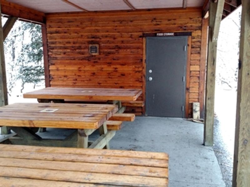 The cook shelter provides a covered place to prepare and eat, as well as secure storage for all food.