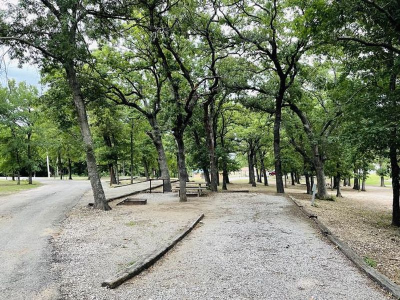 A photo of facility CANEY CREEK with Picnic Table, Electricity Hookup, Fire Pit, Shade, Water Hookup