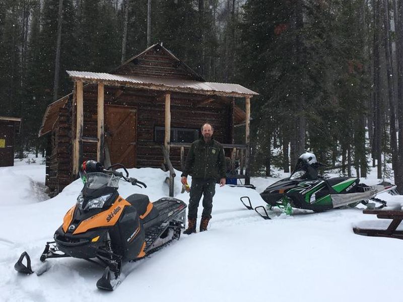 winter cabin check on snowmobiles