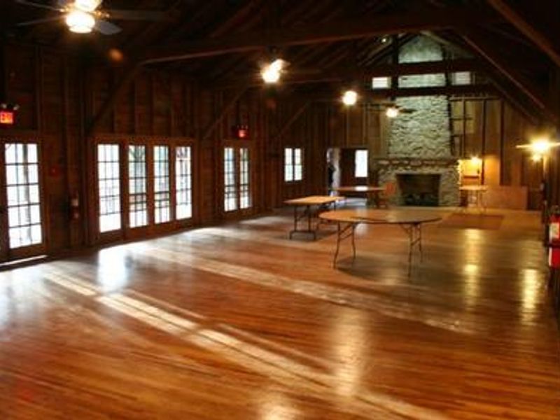 Main room with tables, fireplace and lighting for Appalachian Club House