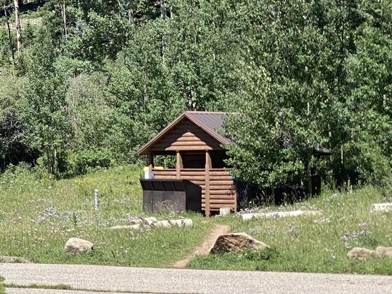 Vault Toilet with bear-proof trash cans