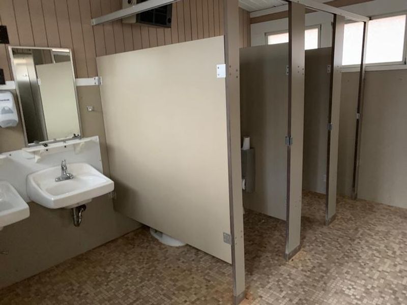 Each of the two comfort stations are divided and have separate facilities for women and men. Both  have toilets, sinks, mirrors and hand dryers. They are cleaned and stocked daily with hand soap and toilet paper. 