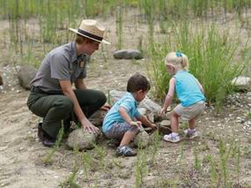 Park ranger with kids in the nature play area at the Paul H Douglas Center area in the Indiana Dunes National Park.