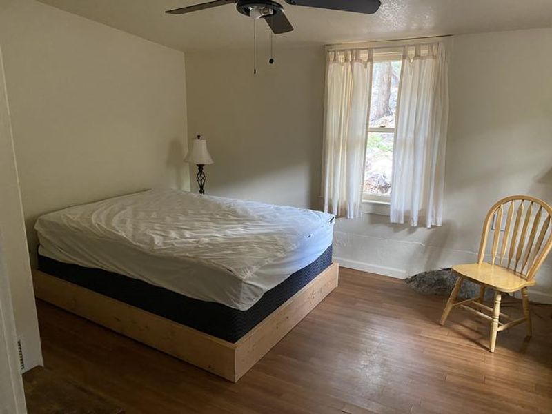 This is the front bedroom. Beds and electricity provided throughout the cabin, but guests are reminded to bring their own bedding and a backup light source (such as a headlamp).