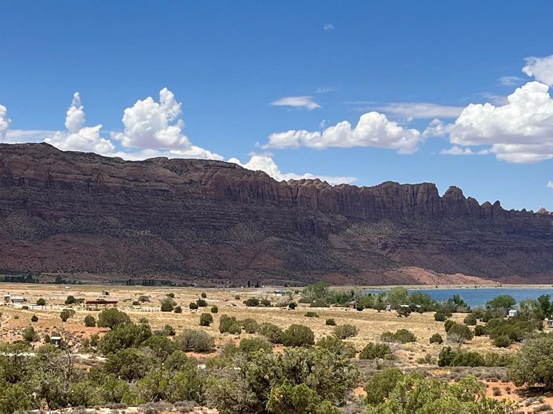 Overview of Ken's Lake Campground with red rock cliffs lining the horizon.