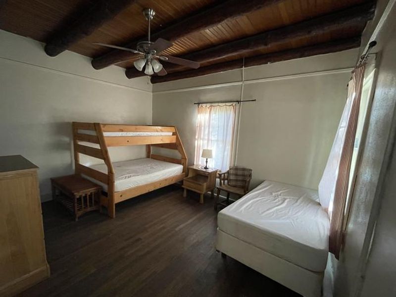 Bedroom of Portal Bunkhouse, including full bed and bunk bed with twin & full mattresses.
