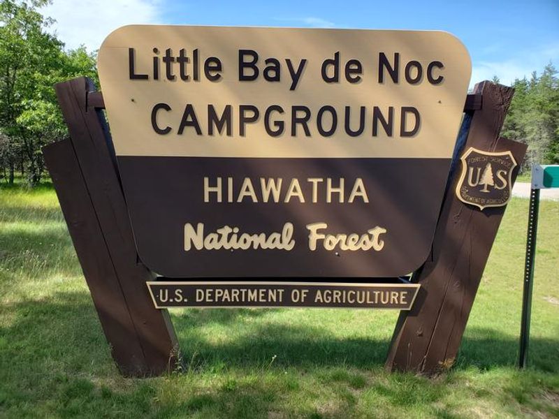 Signage located on County Road 513, indicating the location of the Little Bay de Noc campground