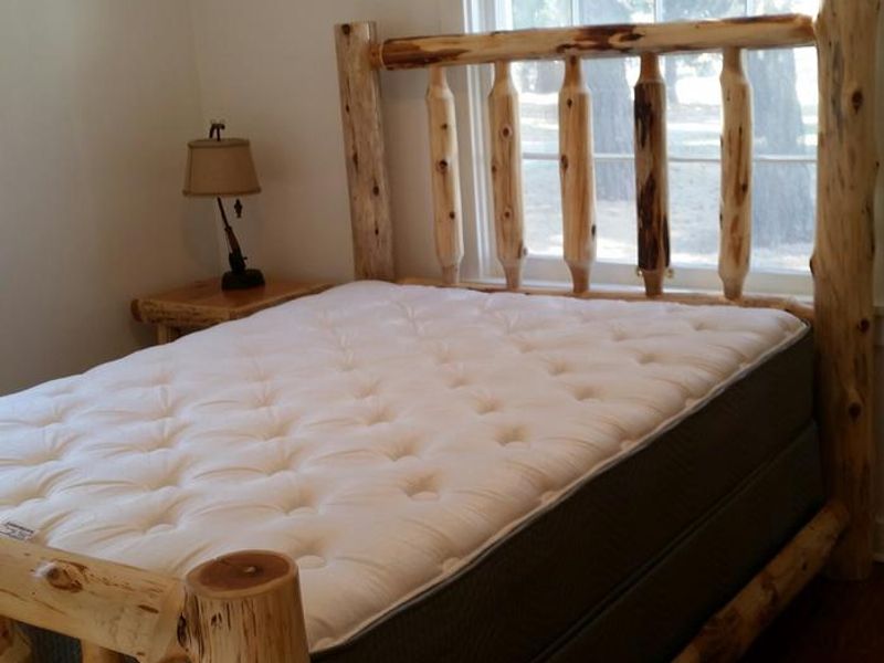 Queen bed and furniture in East Cottage.