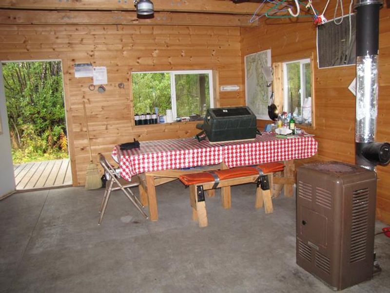 An interior view of a table and heater inside Esker Stream Cabin (Wrangell-St Elias)
