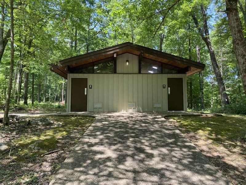 Bathhouse for campers with hot showers, flushable toilets, and sinks.