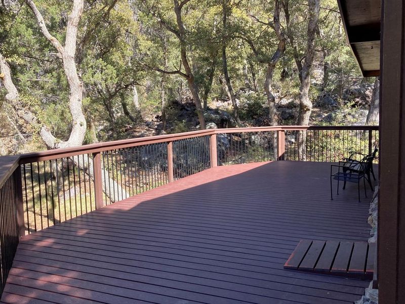Two of the cabin's three bedrooms exit to the large wrap around porch with plenty of space for birding, entertaining, and listening to the spring trickle through the stream bed below.