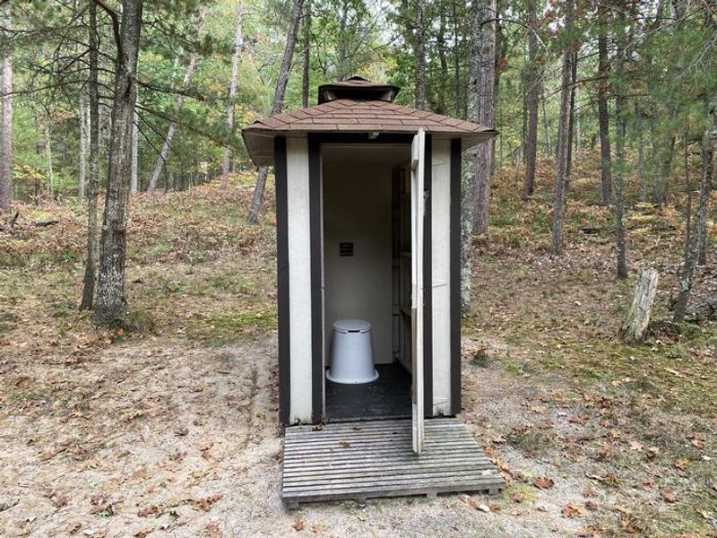 pit toilet with door open