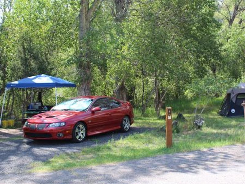 Great for tent camping with green grass and creekside tables.