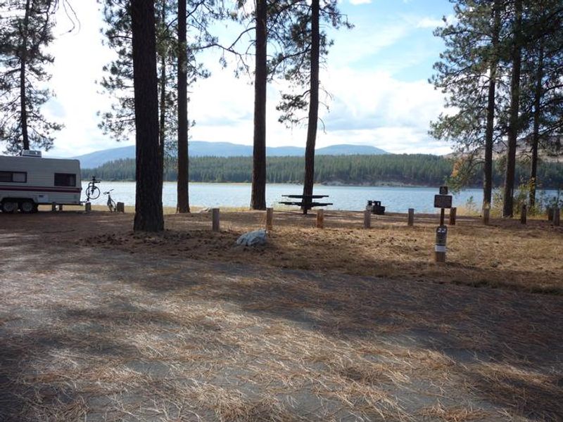 Gifford Campground with trees and lake in the background.