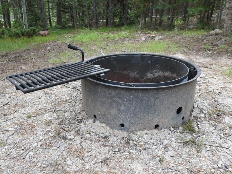 Example of the fire rings located throughout the campground (with grill)