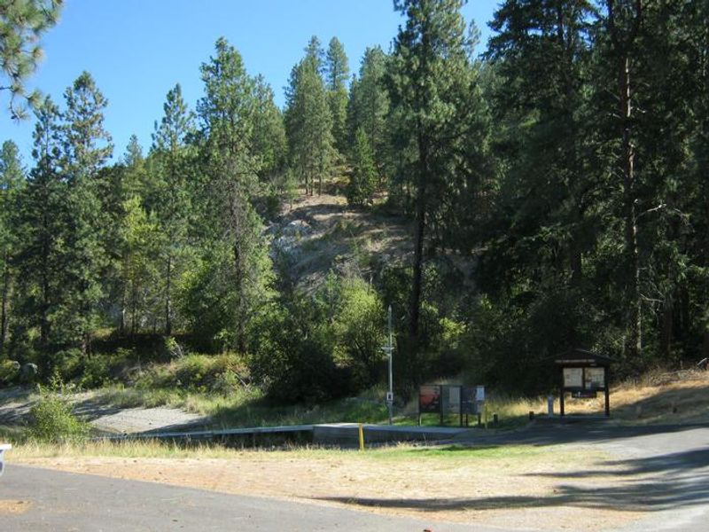 Boat Launch and Information Board. Water and Trees in the background.