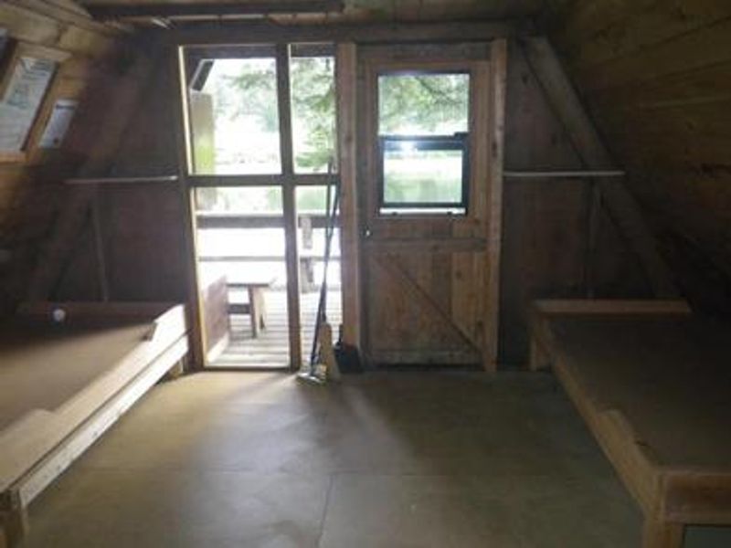 Mount Rynda Cabin interior showing on wood beds, window and door