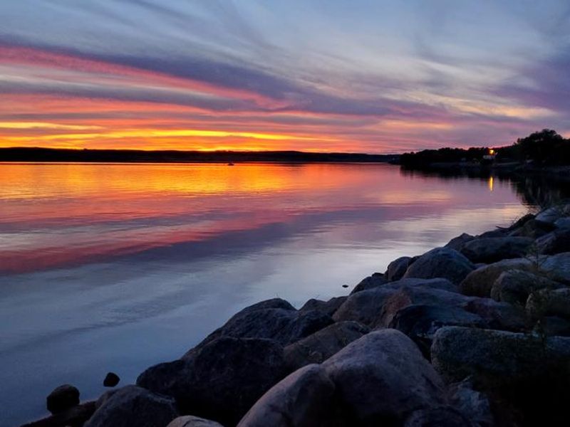 A lone boat returning to the boat dock after enjoying some time out on the water.