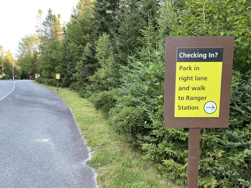 Camper check in sign stating- park in right lane and walk to Ranger Station. Don't forget your ID, park pass and license plate number!