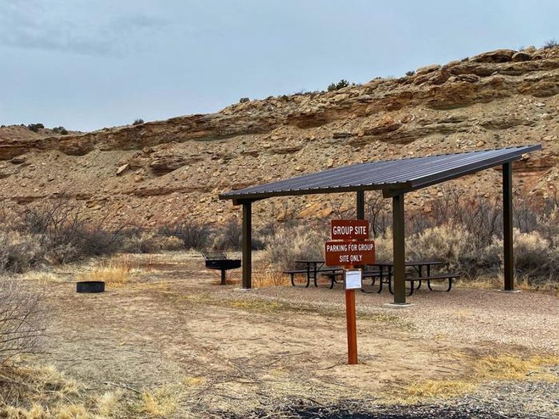 Westwater Group Site picnic tables underneath shade shelter.