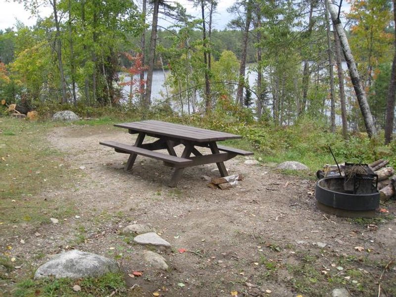 Typical campsite near the lake.  Most sites provide small parking spur with steps to access table, firegrate, and tent pad.