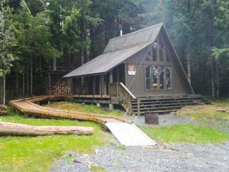 Exterior of the cabin with ramp and woodshed