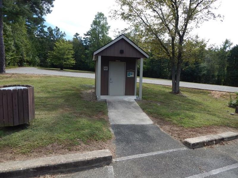 This is a vault toilet that is located near the boat ramp.