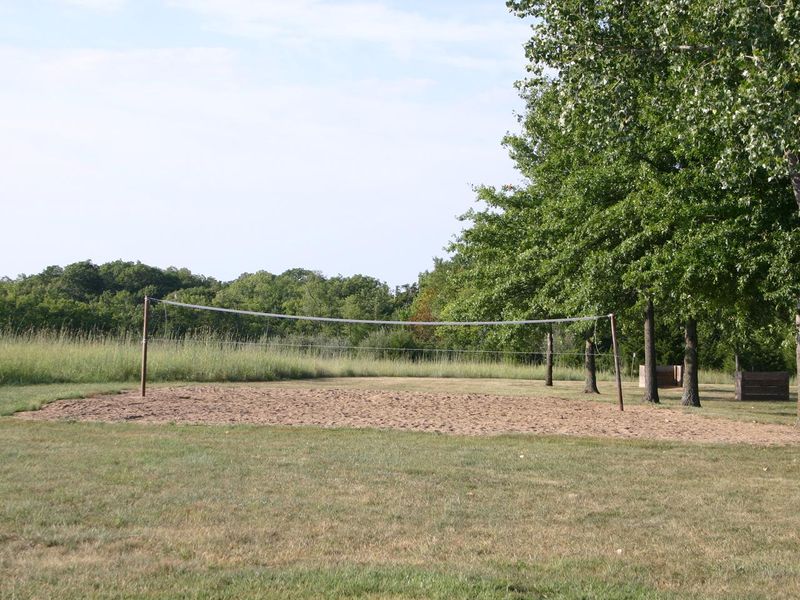 a sand volleyball court is located at the west end of the camping area near the shelter