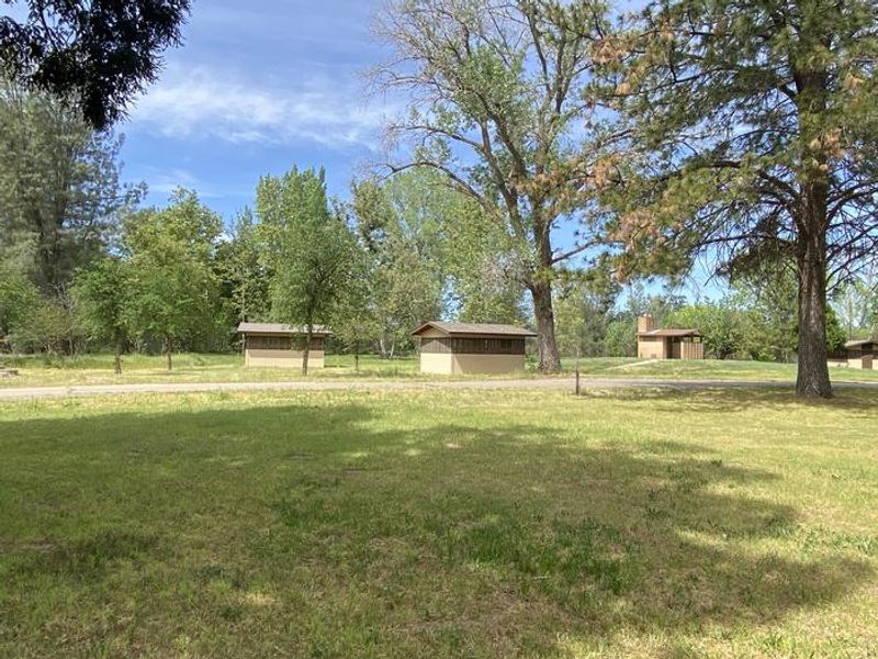 A group of sleeping cabins and vault toilet