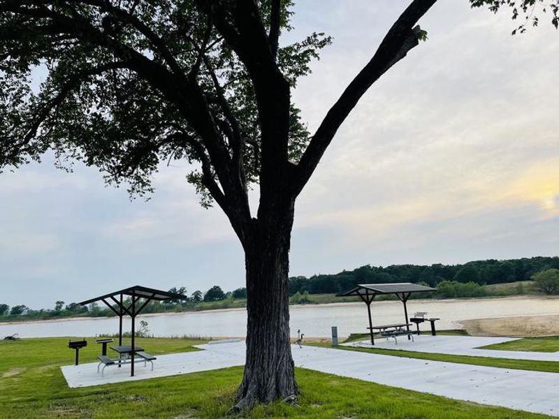 A photo of facility BURNS RUN EAST with Picnic Table, Electricity Hookup, Fire Pit, Shade, Waterfront, Water Hookup