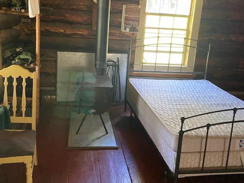 Mattress in bedframe next to window