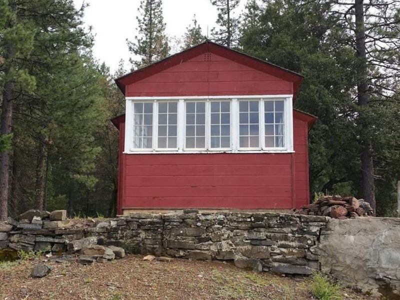 This is the view of the cabin from the back. These windows look out over several mountain ridgelines offering guests beautiful views.