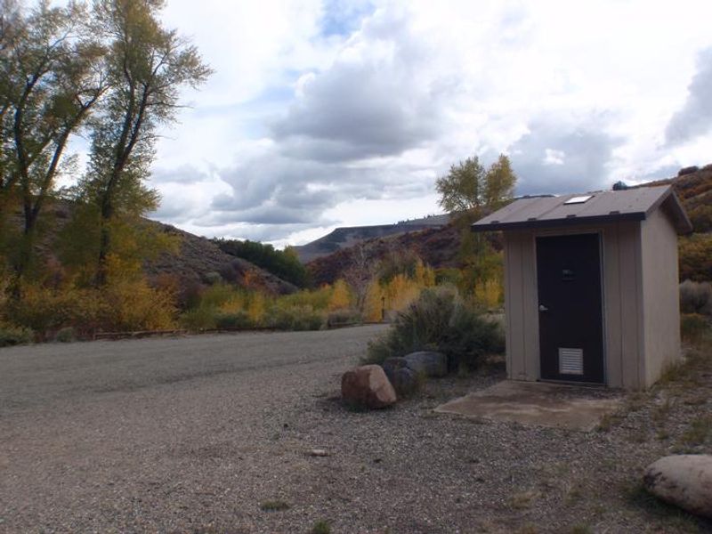 Vault toilet located in parking area