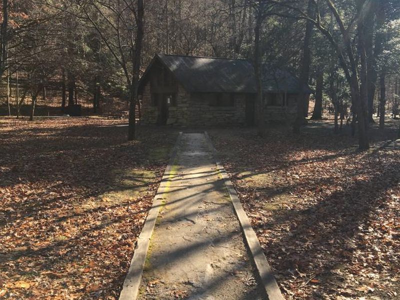 A paved walkway leading to men and women's restrooms 