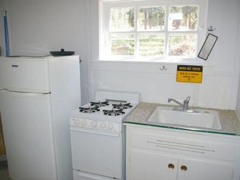 propane fridge and cookstove, sink for summer use.