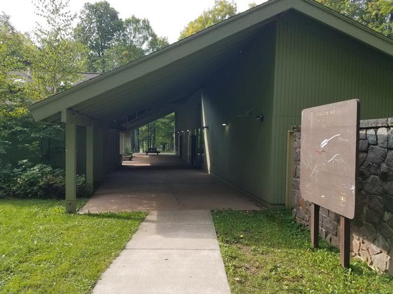 The covered area just outside the Clark Lake pavilion as you approach from the parking lot.